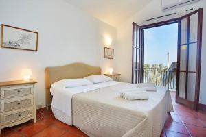 a bedroom with two beds and a balcony at Villa Maravigghia in Castellammare del Golfo
