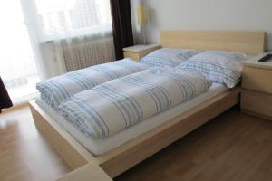 a bed with blue and white pillows on it at Apartments Mayen in Mayen