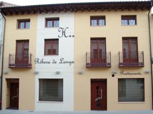 a building with a sign on the side of it at Hotel Ribera de Langa in Langa de Duero