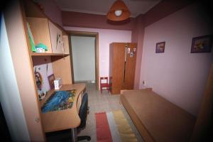 a small bedroom with a bed and a desk at WELCOME TO THESSALONIKI (ΑΜΑ00000765004) in Thessaloniki