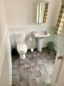 a bathroom with a toilet and a sink at Studio3 Ave house in Scarborough