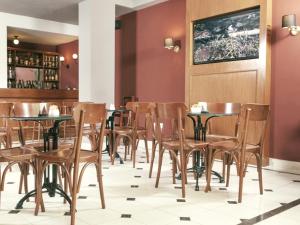 a row of tables and chairs in a restaurant at Solar De La Plaza in Salta