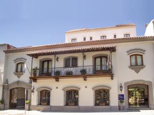 a large white building with a balcony at Solar De La Plaza in Salta