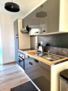 a kitchen with a sink and a counter top at Appartement l'Insolite in Vernet-les-Bains