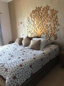 a bedroom with a bed with a wooden headboard at LA BELLA VIDA in Saïdia +26 photos