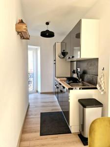 a kitchen with a sink and a counter at Appartement l'Insolite in Vernet-les-Bains