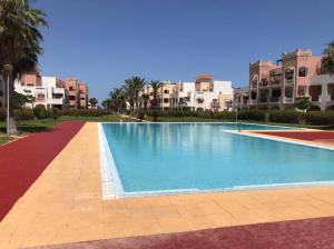 a large swimming pool in front of some apartments at LA BELLA VIDA in Saïdia