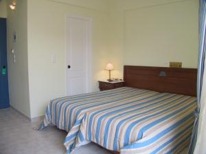 A bed or beds in a room at Florena Hotel