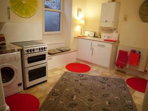 a small kitchen with a stove and a sink at Montrose Apartment in Selkirk