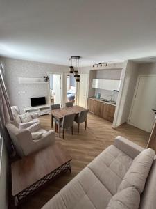 a living room with a couch and a table at Bakuriani Hotel Apartments 301 in Bakuriani