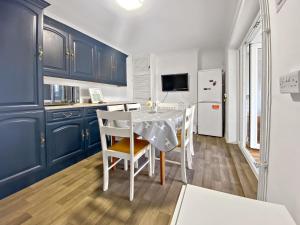 a kitchen and dining room with a table and chairs at Mariners House in King's Lynn