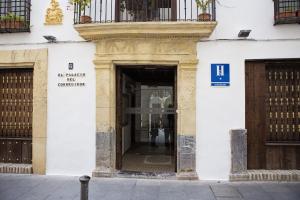 an entrance to a building with a sign on it at Hostal Palacio del Corregidor in Córdoba