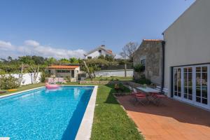 une piscine dans l'arrière-cour d'une maison dans l'établissement Casa de S. Paio - 3 bedroom villa w/ pool & garden, à Braga