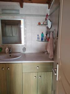 a bathroom with a sink and a mirror at Soubassis House in Elíka