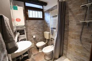 La salle de bains est pourvue de toilettes, d'un lavabo et d'une douche. dans l'établissement Grace Apartment in Venice, à Venise