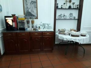 a kitchen with a table and a table with food on it at Hotel Santa Comba in Moura