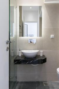 a bathroom with a sink and a mirror at Voda Luxury Residence Penthouse #601 in Athens