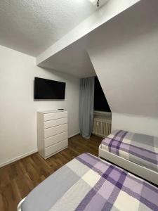 a small bedroom with a bed and a tv at Monteur Wohnung für 4 Personen in Oberhausen. in Oberhausen