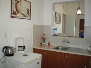 a kitchen with a sink and a mirror at Elli Studios & Apartments in Marathokampos