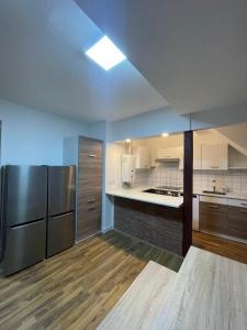 a large kitchen with stainless steel appliances and wooden floors at Monteur Wohnung für 4 Personen in Oberhausen. in Oberhausen