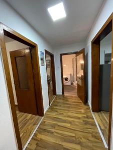 a hallway of a room with doors and wooden floors at Monteur Wohnung für 4 Personen in Oberhausen. in Oberhausen