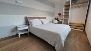 a bedroom with a large white bed and a desk at Agriturismo Tenuta Valletti. in Sesta Godano +83 photos