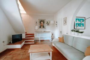 a living room with a couch and a tv at Casa di Giò in Pula