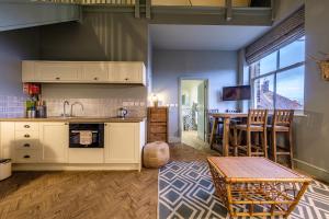 a kitchen and living room with a table and chairs at The Globe Inn in Wells next the Sea