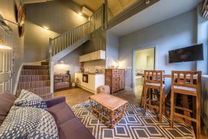a living room with a couch and a kitchen at The Globe Inn in Wells next the Sea
