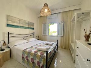 a bedroom with a bed and a chandelier at Casa Malo' in Ischia Town