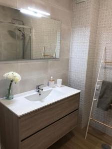 a bathroom with a sink and a mirror at Apartamento T2 Montegordo a 500 m da praia in Monte Gordo
