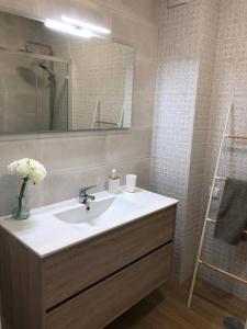a bathroom with a sink and a mirror at Apartamento T2 Montegordo a 500 m da praia in Monte Gordo +5 photos