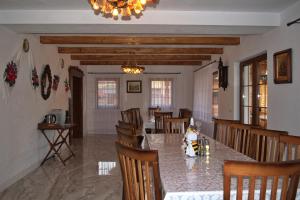 a dining room with a table and chairs at Casa Traditionala Breb in Breb