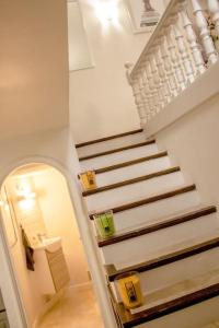 a staircase in a house with a white stair case at Gite en Provence proche Avignon in Sauveterre