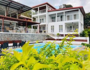 a villa with a swimming pool in front of a house at TSINGONI VILLAGE Meublé de Tourisme in Tsingoni +17 photos