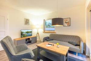 a living room with a couch and chairs and a table at Haus Hanni Zarrentin am Schaalsee in Zarrentin