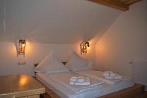 a bedroom with two beds with towels on them at Casa Traditionala Breb in Breb