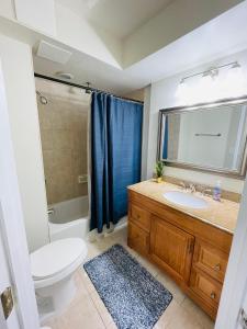 a bathroom with a toilet sink and a shower at Cozy home with rooftop deck-downtown baltimore in Baltimore