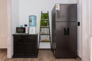 a kitchen with a refrigerator next to a counter and aounter at Casa Solcor Boutique Bed & Breakfast in San Pedro de Atacama