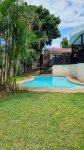 a swimming pool in the yard of a house at 5 OYSTER COTTAGE in Durban