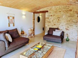 a living room with two couches and a table at Mas Oms in Montnegre