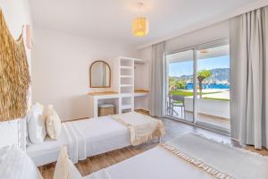 a bedroom with a bed and a large window at selimiye base in Marmaris