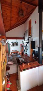 a living room with a couch and a staircase at Tu Casa Rural in Castilblanco de los Arroyos