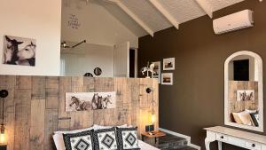 a room with a bed and a wall with pictures on it at Black Horse Estate in Magaliesburg