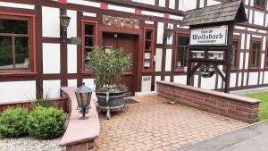 a building with a sign on the side of it at Haus am Wolfsbach in Zorge