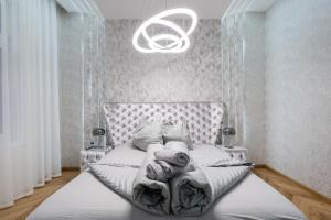 a bedroom with a bed with a chandelier at Heart of Budapest Luxury Apartment with Amazing View in Budapest