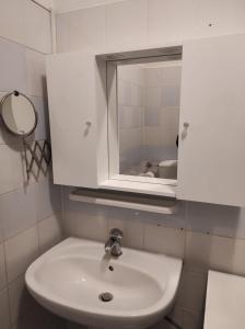 a bathroom with a white sink and a mirror at Casina di mezzo in Borgo a Buggiano