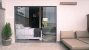 a glass door leading to a bedroom with a bed at Pousada Monttana in Lavras Novas