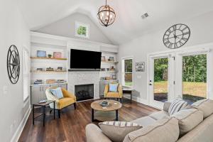 a living room with a couch and a fireplace at Relax, Rewind, Repeat - New Country Cottage in High Point