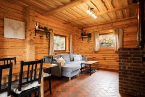 a living room with a couch in a log cabin at House of Sparkles in Elektrėnai